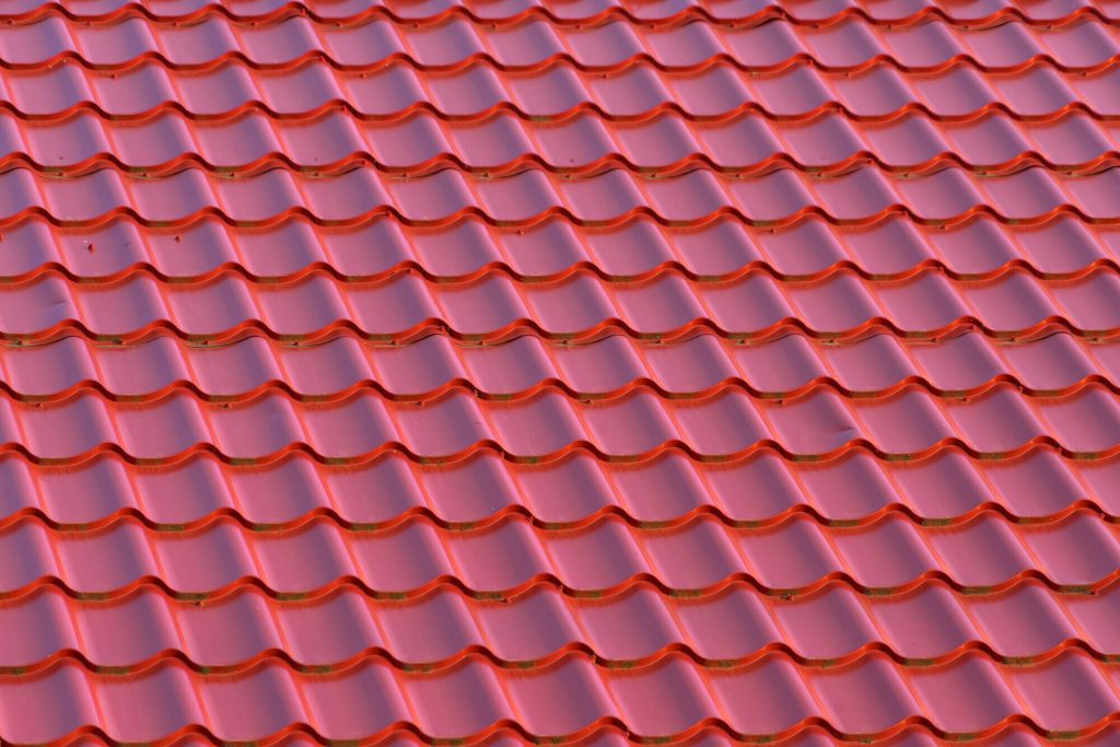 Roof,of,a,rural,house,with,modern,red,metal,roof